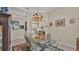 Formal dining room features a glass-top table and views into the living room at 875 Hanover Way, Lakeland, FL 33813