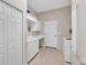 Bright laundry room with built-in cabinets and countertop workspace at 875 Hanover Way, Lakeland, FL 33813