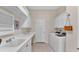 Laundry room with washer, dryer, sink, and ample storage at 875 Hanover Way, Lakeland, FL 33813