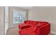 Bright living room featuring a large red sectional sofa and ample natural light at 875 Hanover Way, Lakeland, FL 33813