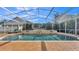 Inviting screened pool with stone waterfall feature at 875 Hanover Way, Lakeland, FL 33813