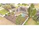 Aerial view of a house with a pool and fenced backyard at 6714 Highlands Creek Loop, Lakeland, FL 33813