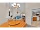 Open dining room with wood table and chairs, adjacent to kitchen at 6714 Highlands Creek Loop, Lakeland, FL 33813