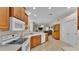 Kitchen features wood cabinets, modern appliances, and a breakfast bar at 6714 Highlands Creek Loop, Lakeland, FL 33813