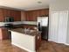 Spacious kitchen with island and wood cabinets at 1038 Suffragette Cir, Haines City, FL 33844