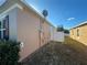 Side of house with white vinyl fence and access gate at 1038 Suffragette Cir, Haines City, FL 33844