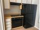 Kitchen features a black refrigerator and range at 1041 Heron Ct, Kissimmee, FL 34759