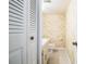 Small bathroom with toilet and patterned wallpaper at 1130 N Lake Parker Ave # A202, Lakeland, FL 33805