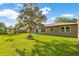 Backyard featuring a healthy lawn, established landscaping, and space for outdoor activities at 123 Padgett N Pl, Lakeland, FL 33809