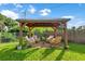 Inviting backyard pergola with comfortable seating, perfect for outdoor relaxation and entertaining at 123 Padgett N Pl, Lakeland, FL 33809