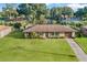 Aerial view of home highlighting curb appeal with a green lawn and mature trees at 123 Padgett N Pl, Lakeland, FL 33809