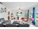 Bright living room featuring tile flooring, a ceiling fan, and a large window with natural light at 123 Padgett N Pl, Lakeland, FL 33809