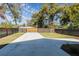 Large backyard with a long driveway and a black metal fence at 127 W Belmar St, Lakeland, FL 33803