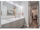 Well-lit bathroom featuring double sinks, a large mirror, and a walk-in closet at 127 W Belmar St, Lakeland, FL 33803