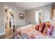 Cozy bedroom with a decorative bedspread, neutral walls and an adjoining closet at 127 W Belmar St, Lakeland, FL 33803