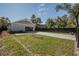 Detached garage with a long driveway surrounded by a well-kept lawn at 127 W Belmar St, Lakeland, FL 33803