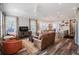 Open-concept living room featuring hardwood floors, ceiling fan, and a comfortable seating arrangement at 127 W Belmar St, Lakeland, FL 33803