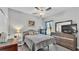 Bright bedroom with a ceiling fan, large dresser with television and window with blackout curtains at 1336 Melrose St, Lake Alfred, FL 33850