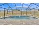 Paver pool deck offers a relaxing, screened-in pool at 1336 Melrose St, Lake Alfred, FL 33850