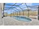 Backyard screened pool with beautiful stone features at 1336 Melrose St, Lake Alfred, FL 33850