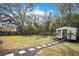 Large backyard with shed and stone pathway at 1418 Grace N St, Lakeland, FL 33810