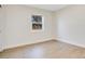 Simple bedroom with a window and wood-look flooring at 1418 Grace N St, Lakeland, FL 33810