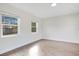 Simple bedroom with two windows and wood-look flooring at 1418 Grace N St, Lakeland, FL 33810