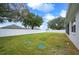 Large backyard with a white vinyl fence at 1427 Magnolia Ln, Auburndale, FL 33823