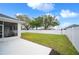 Private backyard with large grassy area and a white fence at 1427 Magnolia Ln, Auburndale, FL 33823