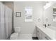 Stylish bathroom with shower/tub combo and gray tile at 1427 Magnolia Ln, Auburndale, FL 33823