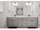 Modern bathroom boasts double vanity, large mirror, and updated fixtures at 1427 Magnolia Ln, Auburndale, FL 33823