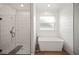 Clean bathroom with a walk-in shower and a free-standing bathtub at 1427 Magnolia Ln, Auburndale, FL 33823