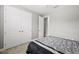 Well-lit bedroom featuring double doors and carpet flooring at 1427 Magnolia Ln, Auburndale, FL 33823