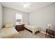 Bedroom with two twin beds, carpet flooring, and window at 1427 Magnolia Ln, Auburndale, FL 33823