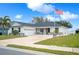 Modern house with a two-car garage and American flag at 1427 Magnolia Ln, Auburndale, FL 33823