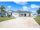 House exterior featuring a two-car garage and landscaping at 1427 Magnolia Ln, Auburndale, FL 33823