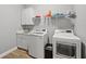 Clean laundry room, washer, dryer, and built in cabinets at 1427 Magnolia Ln, Auburndale, FL 33823