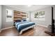 Main bedroom with wood-look floors and a stylish headboard at 1427 Magnolia Ln, Auburndale, FL 33823