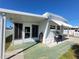 White mobile home with covered porch and awning at 1540 Skyview Ct, Lakeland, FL 33801