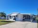 White single wide home with carport and large yard at 1540 Skyview Ct, Lakeland, FL 33801