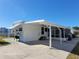 Front view of a white single wide home with covered porch at 1540 Skyview Ct, Lakeland, FL 33801