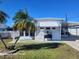 White single-wide manufactured home with carport and palm trees at 1540 Skyview Ct, Lakeland, FL 33801