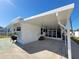 Side view of a white mobile home with covered patio at 1540 Skyview Ct, Lakeland, FL 33801