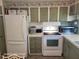 White appliances and green cabinets in this kitchen at 1540 Skyview Ct, Lakeland, FL 33801