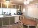 Kitchen with green cabinets, round dining table and appliances at 1540 Skyview Ct, Lakeland, FL 33801