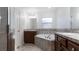 Bathroom with double vanity, soaking tub, and walk-in shower at 155 Kissengen Park Blvd, Bartow, FL 33830