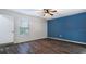 Spacious bedroom with dark wood-look floors and blue accent wall at 155 Kissengen Park Blvd, Bartow, FL 33830