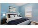 Virtually staged bedroom with light blue walls and a queen bed at 155 Kissengen Park Blvd, Bartow, FL 33830