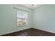 Light blue bedroom with wood-look floors and a window at 155 Kissengen Park Blvd, Bartow, FL 33830