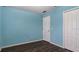 Light blue bedroom with wood-look floors and double doors at 155 Kissengen Park Blvd, Bartow, FL 33830